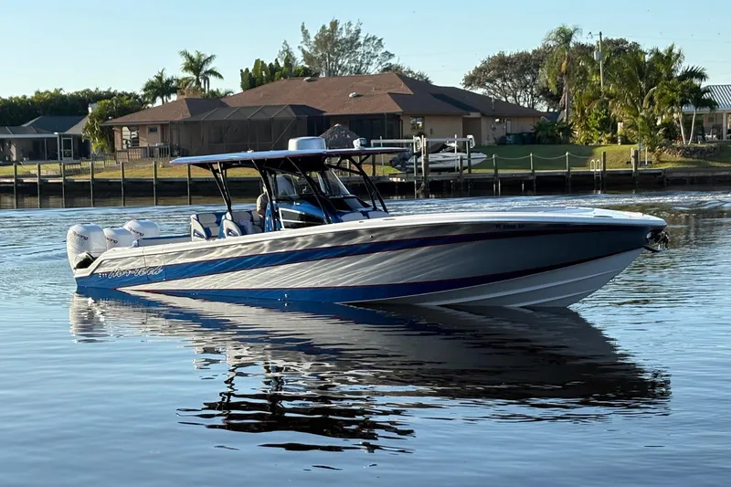  Yacht Photos Pics 2023 Nor-Tech 390 Sport Center Console boat on calm water near residential area.