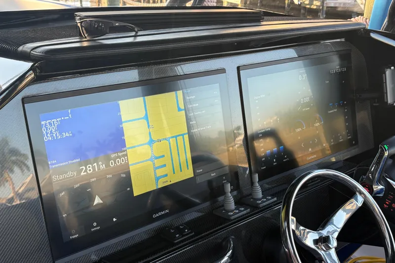  Yacht Photos Pics 2023 Nor-Tech 390 Sport Center Console dashboard with dual Garmin displays and steering wheel.