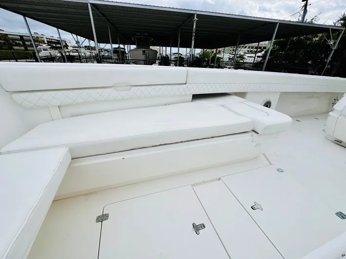  Yacht Photos Pics 2004 Intrepid 370 Open boat interior with white seating and storage compartments.