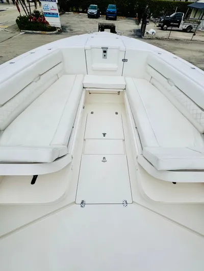  Yacht Photos Pics 2004 Intrepid 370 Open boat with spacious white seating and storage compartments.