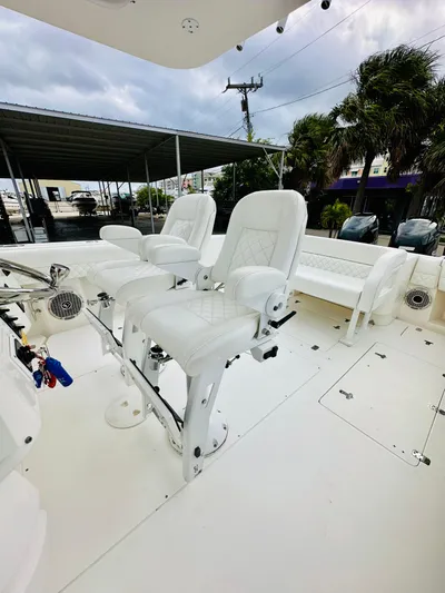  Yacht Photos Pics 2004 Intrepid 370 Open boat with white seating and spacious deck.