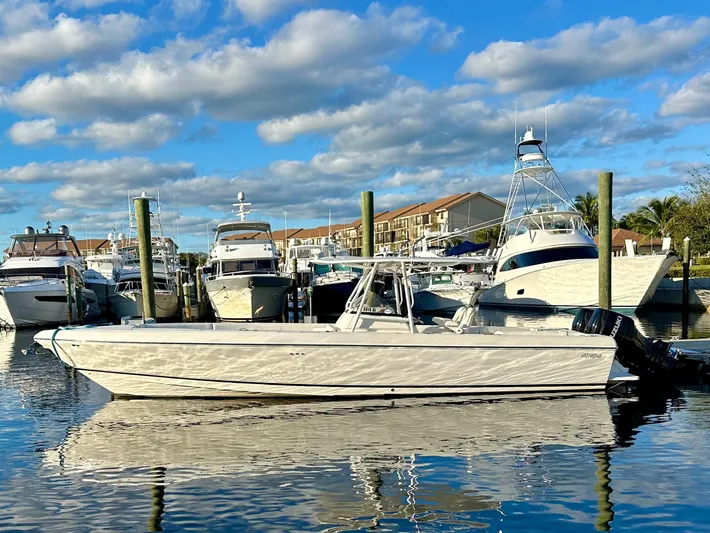  Yacht Photos Pics 2004 Intrepid 370 Open boat docked in a marina under a blue sky.