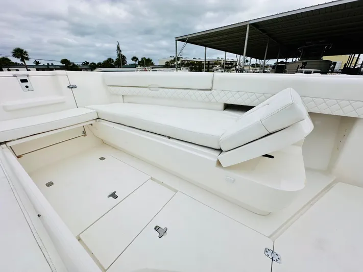  Yacht Photos Pics 2004 Intrepid 370 Open boat interior with white seating and storage compartments.