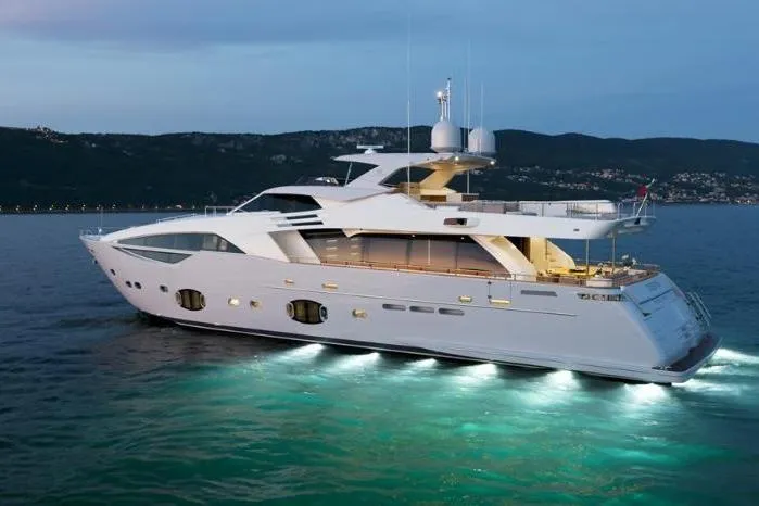 Sha Sha Sha IV Yacht Photos Pics Luxurious 2014 Custom Line 100 yacht illuminated on serene waters at dusk.