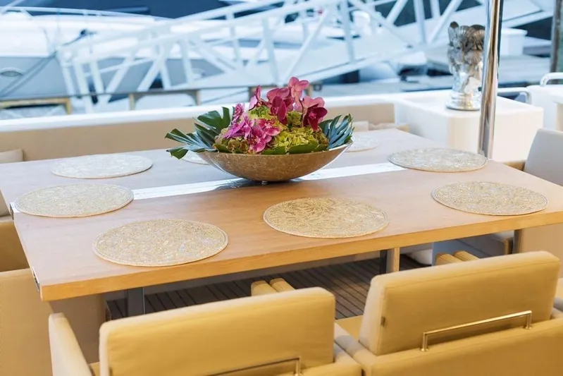 Sha Sha Sha IV Yacht Photos Pics Luxurious yacht dining area with elegant table setting and floral centerpiece, Custom Line 100, 2014.