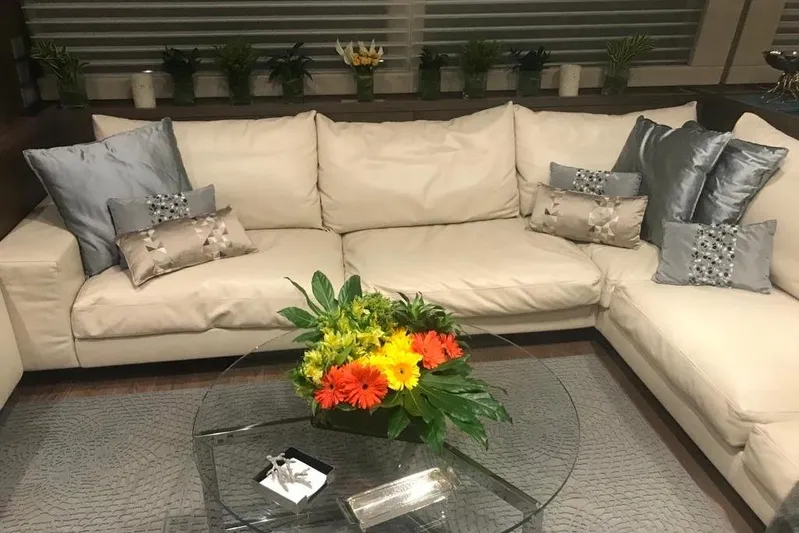 Sha Sha Sha IV Yacht Photos Pics Luxurious living room with cream sofa, decorative pillows, and vibrant floral centerpiece, Custom Line 100, 2014.