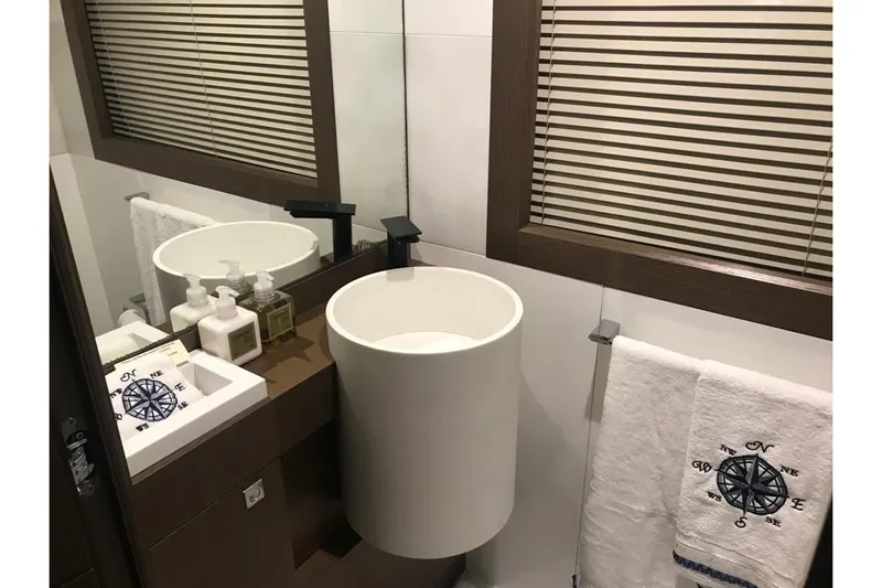 Sha Sha Sha IV Yacht Photos Pics Modern bathroom in Custom Line 100 yacht, 2014, featuring sleek sink and nautical-themed decor.