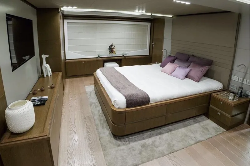 Sha Sha Sha IV Yacht Photos Pics Luxurious yacht bedroom with modern decor, featuring a large bed and elegant furnishings, Custom Line 100, 2014.