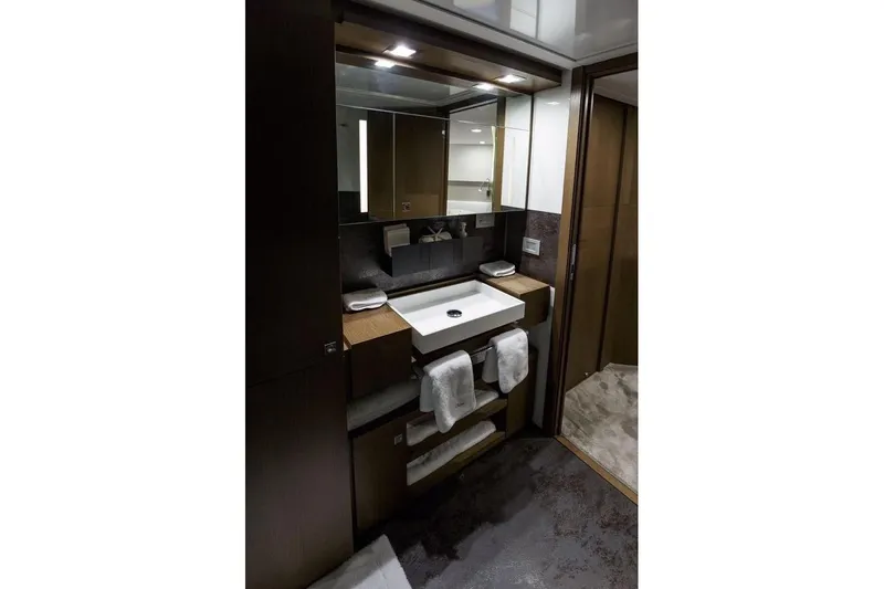 Sha Sha Sha IV Yacht Photos Pics Luxurious yacht bathroom with modern sink, mirror, and towels; Custom Line 100, 2014 model.