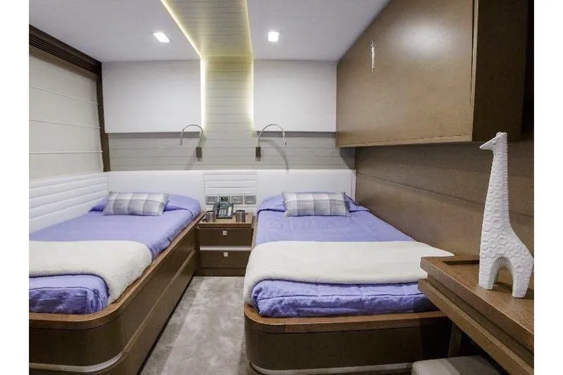 Sha Sha Sha IV Yacht Photos Pics Luxurious twin bedroom on a 2014 Custom Line 100 yacht, featuring modern decor and ambient lighting.