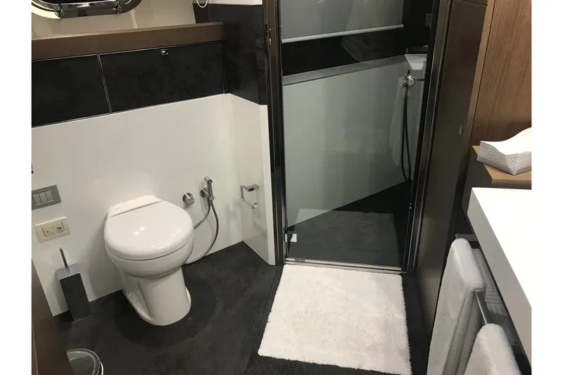 Sha Sha Sha IV Yacht Photos Pics Modern bathroom in Custom Line 100 yacht, 2014 model, featuring toilet and shower.