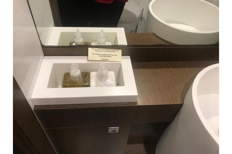 Sha Sha Sha IV Yacht Photos Pics Modern bathroom sink with soap dispensers and a mirror, Custom Line 100 yacht, 2014.