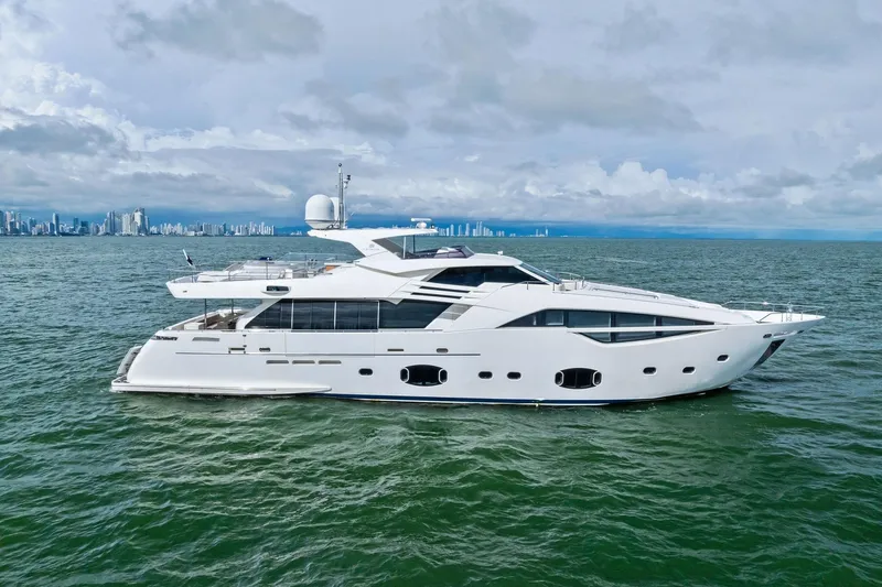 Sha Sha Sha IV Yacht Photos Pics Luxurious 2014 Custom Line 100 yacht cruising on open water with city skyline backdrop.