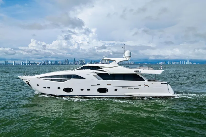 Sha Sha Sha IV Yacht Photos Pics Luxurious 2014 Custom Line 100 yacht cruising near city skyline under cloudy skies.