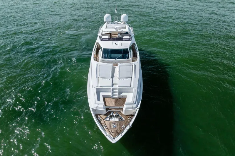 Sha Sha Sha IV Yacht Photos Pics Aerial view of 2014 Custom Line 100 yacht cruising on green ocean waters.