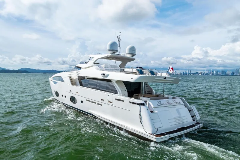 Sha Sha Sha IV Yacht Photos Pics Luxurious 2014 Custom Line 100 yacht cruising on open water with city skyline backdrop.