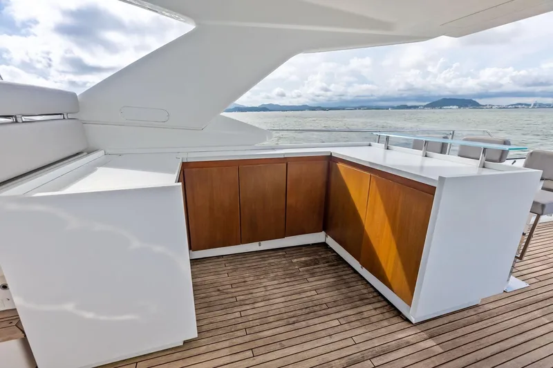 Sha Sha Sha IV Yacht Photos Pics Luxurious yacht deck with wooden cabinetry, Custom Line 100, 2014 model, ocean view.