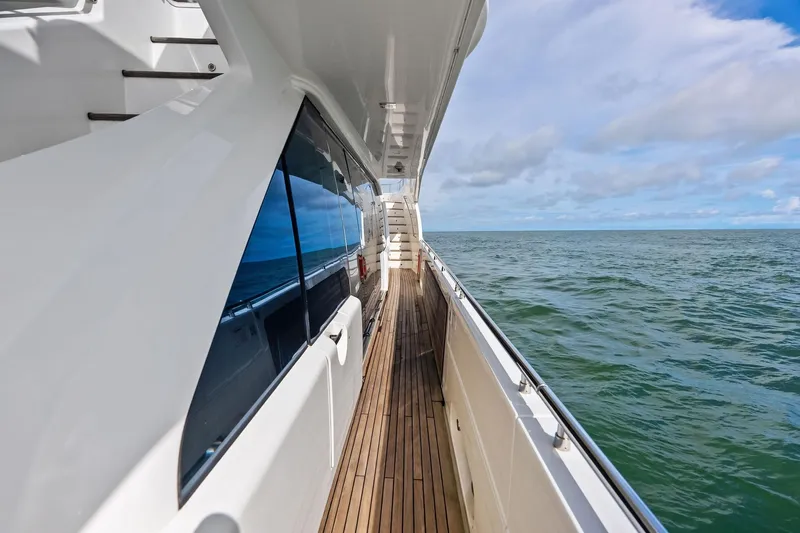 Sha Sha Sha IV Yacht Photos Pics Side deck view of 2014 Custom Line 100 yacht cruising on open sea.