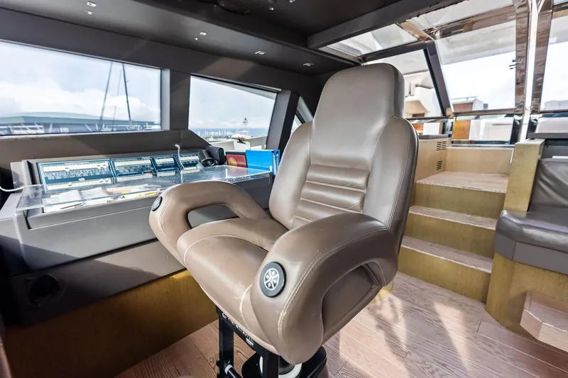 Sha Sha Sha IV Yacht Photos Pics Luxurious helm station of 2014 Custom Line 100 yacht with leather captain's chair.
