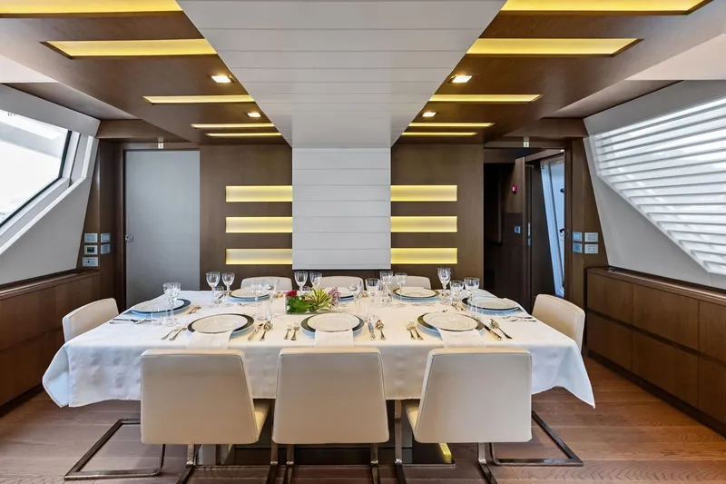Sha Sha Sha IV Yacht Photos Pics Luxurious dining area on 2014 Custom Line 100 yacht, featuring elegant table setting and modern design.