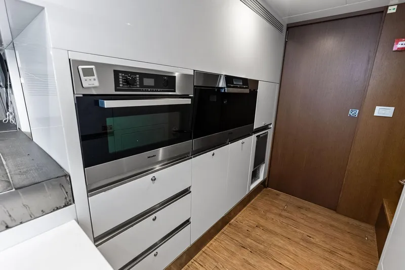 Sha Sha Sha IV Yacht Photos Pics Modern kitchen with built-in stainless steel appliances, Custom Line 100 yacht, 2014 model.