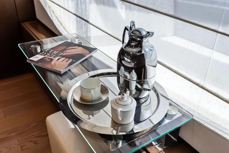 Sha Sha Sha IV Yacht Photos Pics Luxurious yacht interior with coffee set and magazine on glass table, Custom Line 100, 2014.