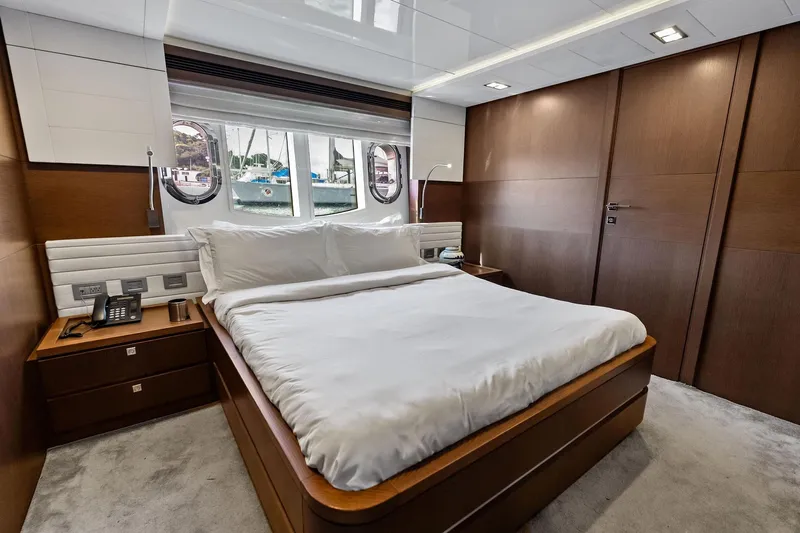 Sha Sha Sha IV Yacht Photos Pics Luxurious bedroom interior on 2014 Custom Line 100 yacht with elegant wood finishes.