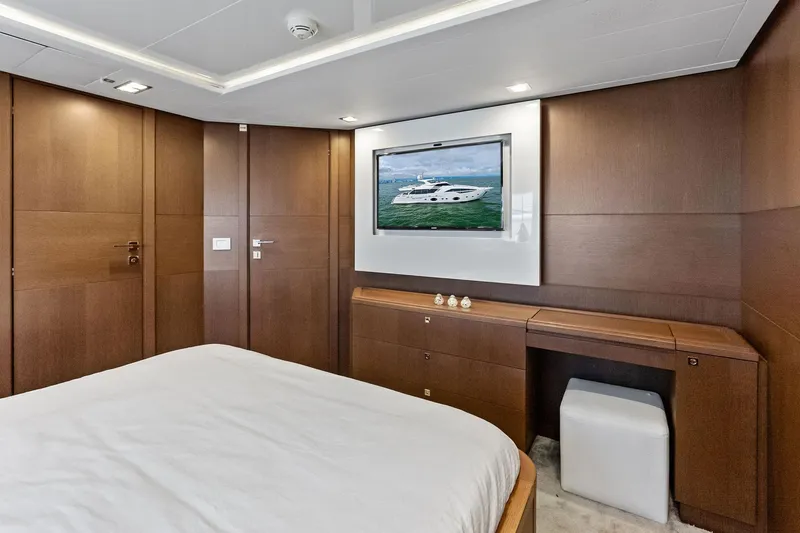 Sha Sha Sha IV Yacht Photos Pics Luxurious yacht bedroom with wood paneling, TV, and modern decor, Custom Line 100, 2014 model.