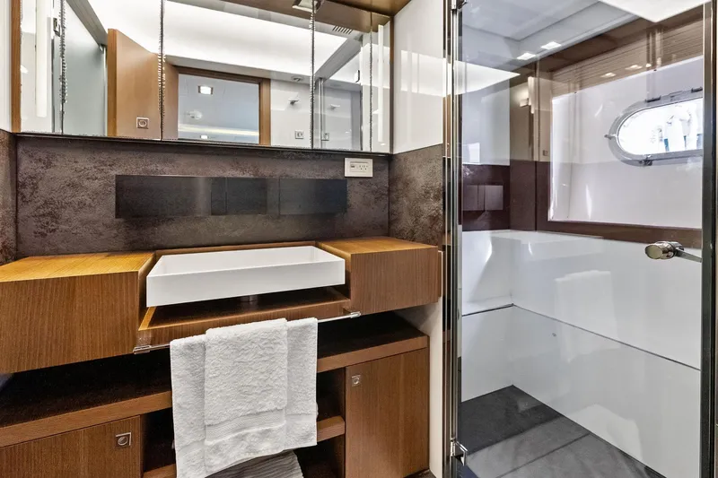 Sha Sha Sha IV Yacht Photos Pics Luxurious yacht bathroom with modern sink, wooden cabinetry, and glass shower, Custom Line 100, 2014.