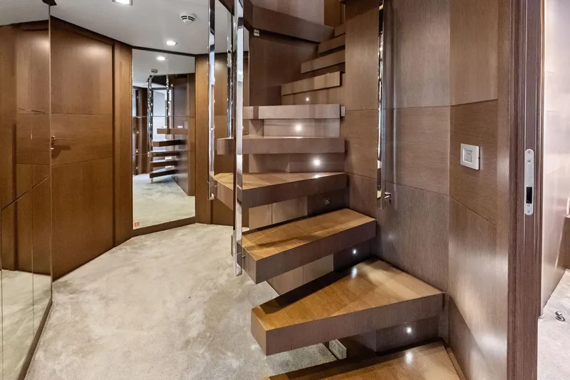 Sha Sha Sha IV Yacht Photos Pics Modern wooden staircase with sleek design in a Custom Line 100 yacht, 2014 model.