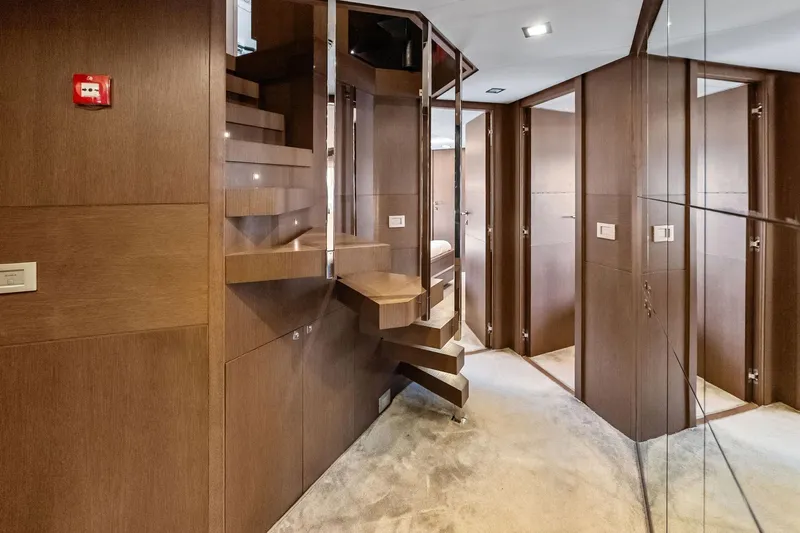 Sha Sha Sha IV Yacht Photos Pics Luxurious interior of 2014 Custom Line 100 yacht with modern wooden staircase design.