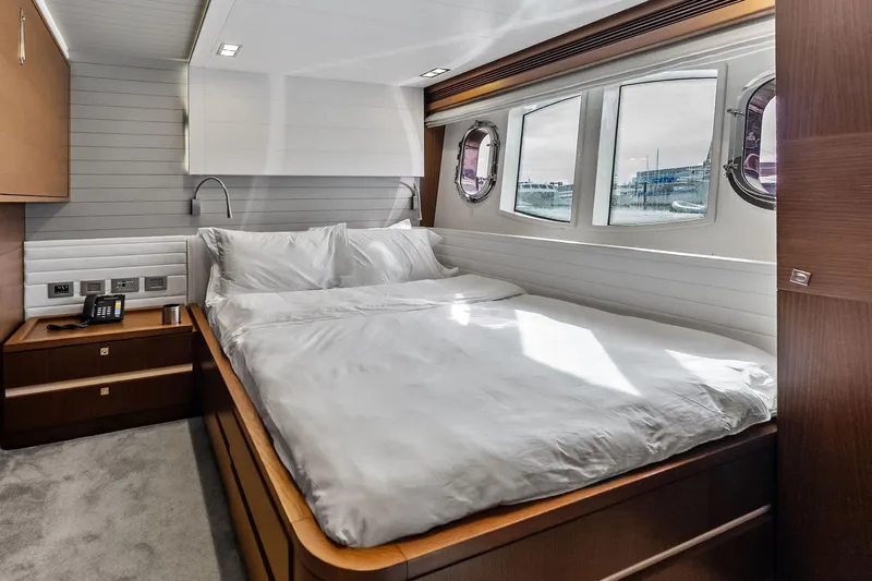 Sha Sha Sha IV Yacht Photos Pics Luxurious 2014 Custom Line 100 yacht bedroom with elegant wood finishes and large windows.