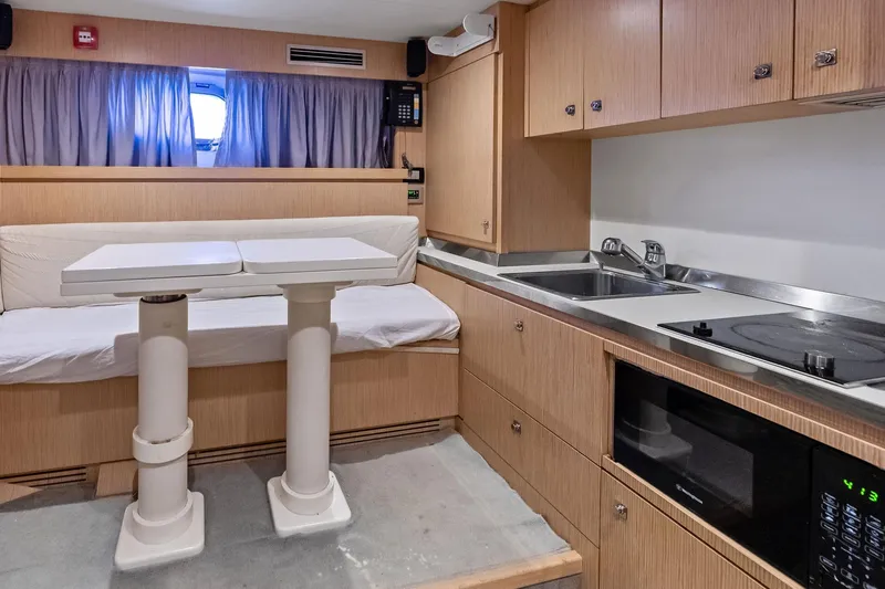 Sha Sha Sha IV Yacht Photos Pics Luxurious 2014 Custom Line 100 yacht interior with modern kitchen and dining area.