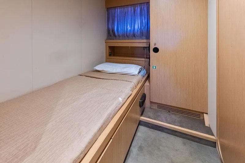 Sha Sha Sha IV Yacht Photos Pics Small cabin interior with single bed, wooden paneling, and window on a 2014 Custom Line 100 yacht.