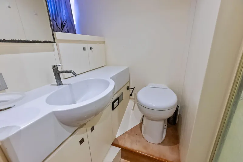 Sha Sha Sha IV Yacht Photos Pics Compact bathroom in 2014 Custom Line 100 yacht with sink and toilet.