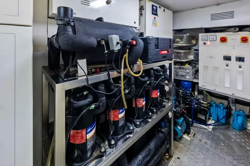 Sha Sha Sha IV Yacht Photos Pics Engine room of a 2014 Custom Line 100 yacht with machinery and control panels.