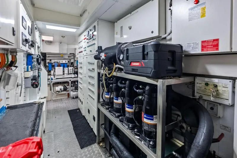 Sha Sha Sha IV Yacht Photos Pics Engine room of 2014 Custom Line 100 yacht with control panels and equipment.