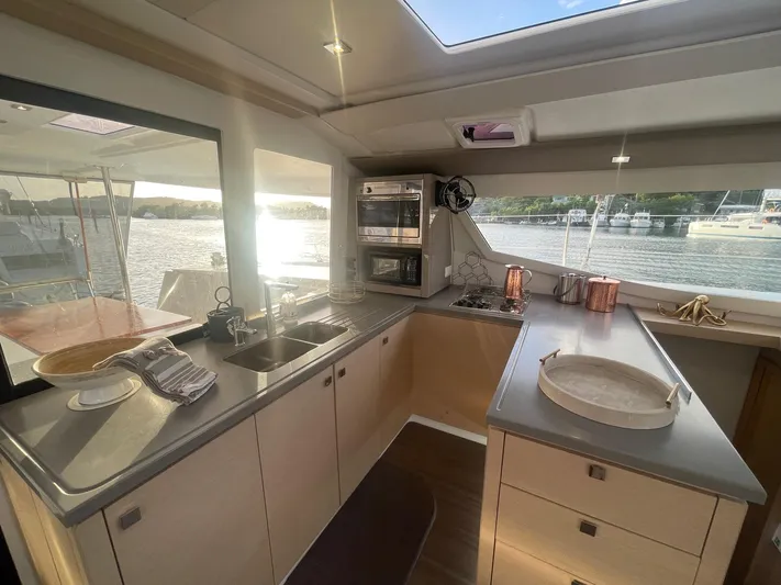 Carpe Aura Yacht Photos Pics Modern kitchen interior on 2018 Fountaine Pajot Helia 44 catamaran with scenic water view.