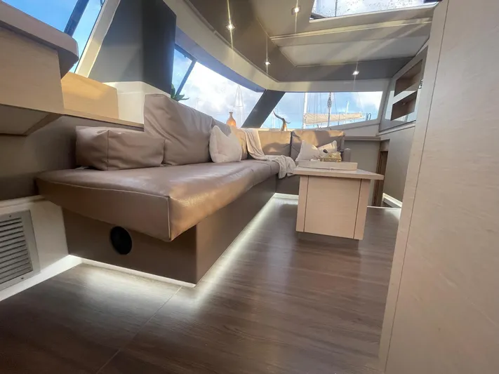 Carpe Aura Yacht Photos Pics Luxurious interior of 2018 Fountaine Pajot Helia 44 catamaran with modern seating and natural light.