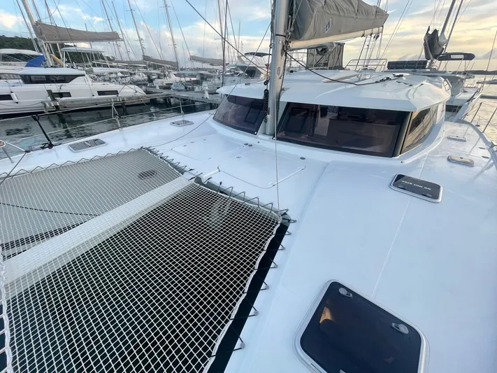 Carpe Aura Yacht Photos Pics Fountaine Pajot Helia 44 catamaran, 2018 model, docked at marina with netted deck.