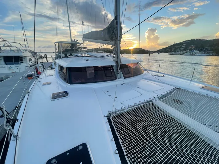 Carpe Aura Yacht Photos Pics Fountaine Pajot Helia 44 catamaran, 2018 model, docked at sunset with scenic water view.