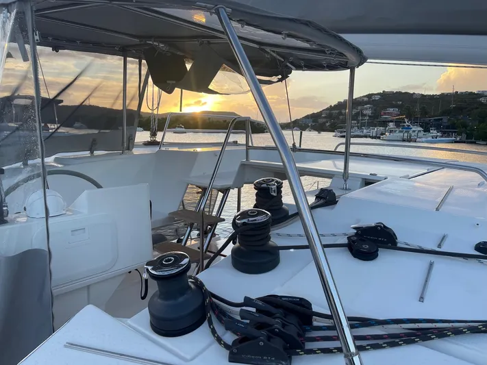 Carpe Aura Yacht Photos Pics Fountaine Pajot Helia 44 catamaran at sunset, 2018 model, docked in a scenic harbor.