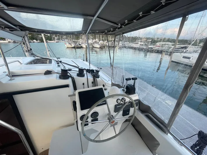 Carpe Aura Yacht Photos Pics Helm of 2018 Fountaine Pajot Helia 44 catamaran docked at marina.