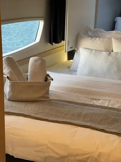 Carpe Aura Yacht Photos Pics Luxurious cabin interior of 2018 Fountaine Pajot Helia 44 catamaran with cozy bedding.