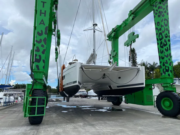 Carpe Aura Yacht Photos Pics Fountaine Pajot Helia 44 catamaran being lifted by green crane, 2018 model.