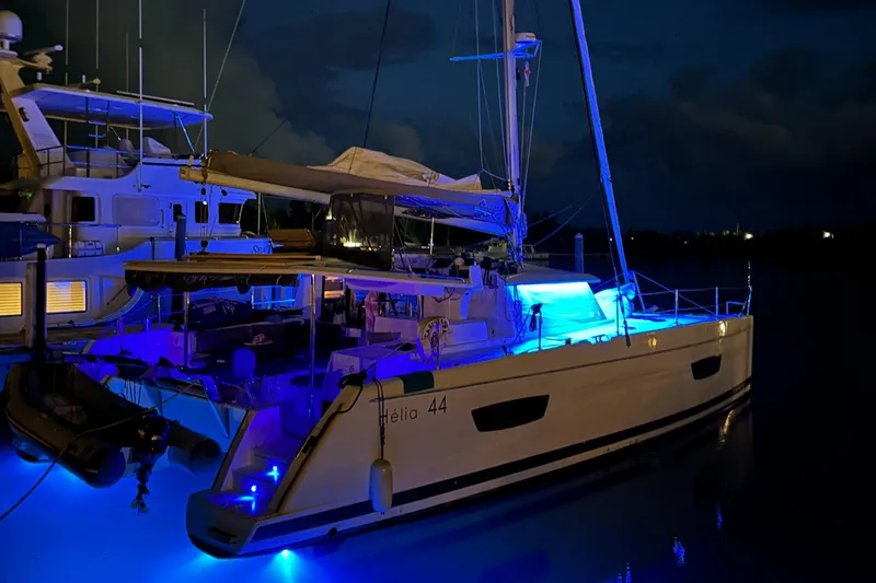 Carpe Aura Yacht Photos Pics 2018 Fountaine Pajot Helia 44 catamaran illuminated with blue lights at night.
