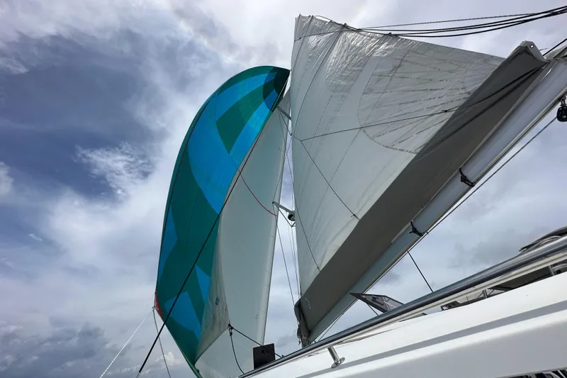 Carpe Aura Yacht Photos Pics Fountaine Pajot Helia 44 sailing with vibrant blue and white sails, 2018 model.