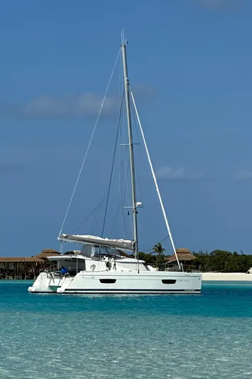 Carpe Aura Yacht Photos Pics 2018 Fountaine Pajot Helia 44 catamaran sailing in clear turquoise waters.