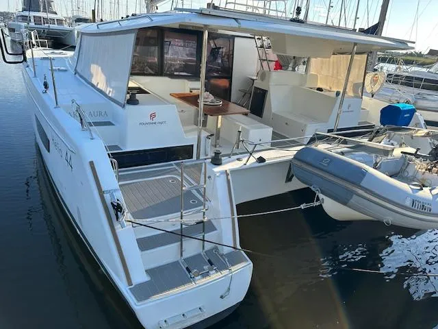 Carpe Aura Yacht Photos Pics 2018 Fountaine Pajot Helia 44 catamaran docked with dinghy attached.