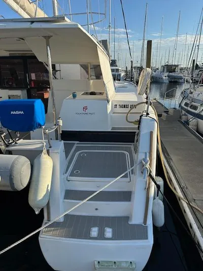 Carpe Aura Yacht Photos Pics 2018 Fountaine Pajot Helia 44 catamaran docked at marina, rear view.